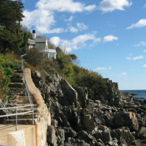 a walkway along the shore of york maine leading up to a residence