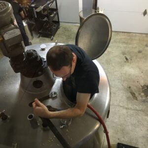 a man climbing into a distill