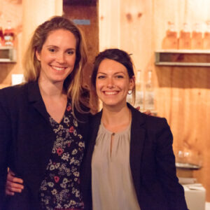 a photo of two woman smiling and posing for a photo at a yelp event